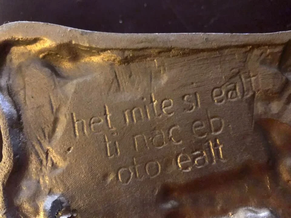 This is a curious code phrase Andrew put on the back of a plaque. Can you figure it out? 