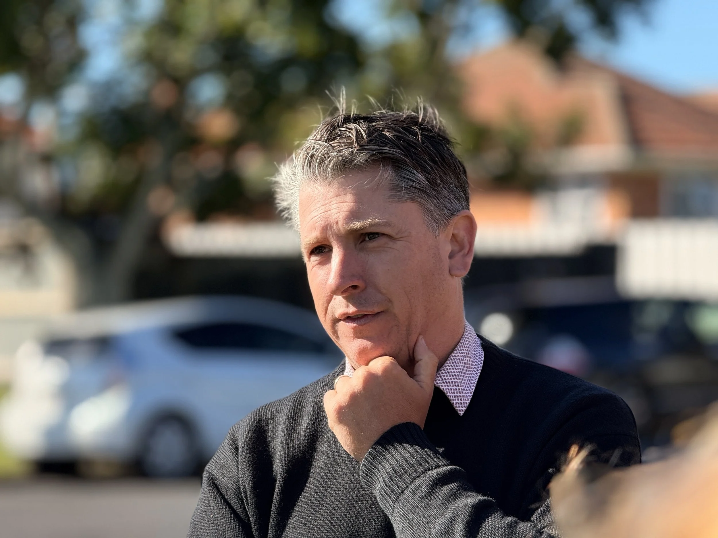 Michael Wood smiling outdoors in Mt Roskill, New Zealand