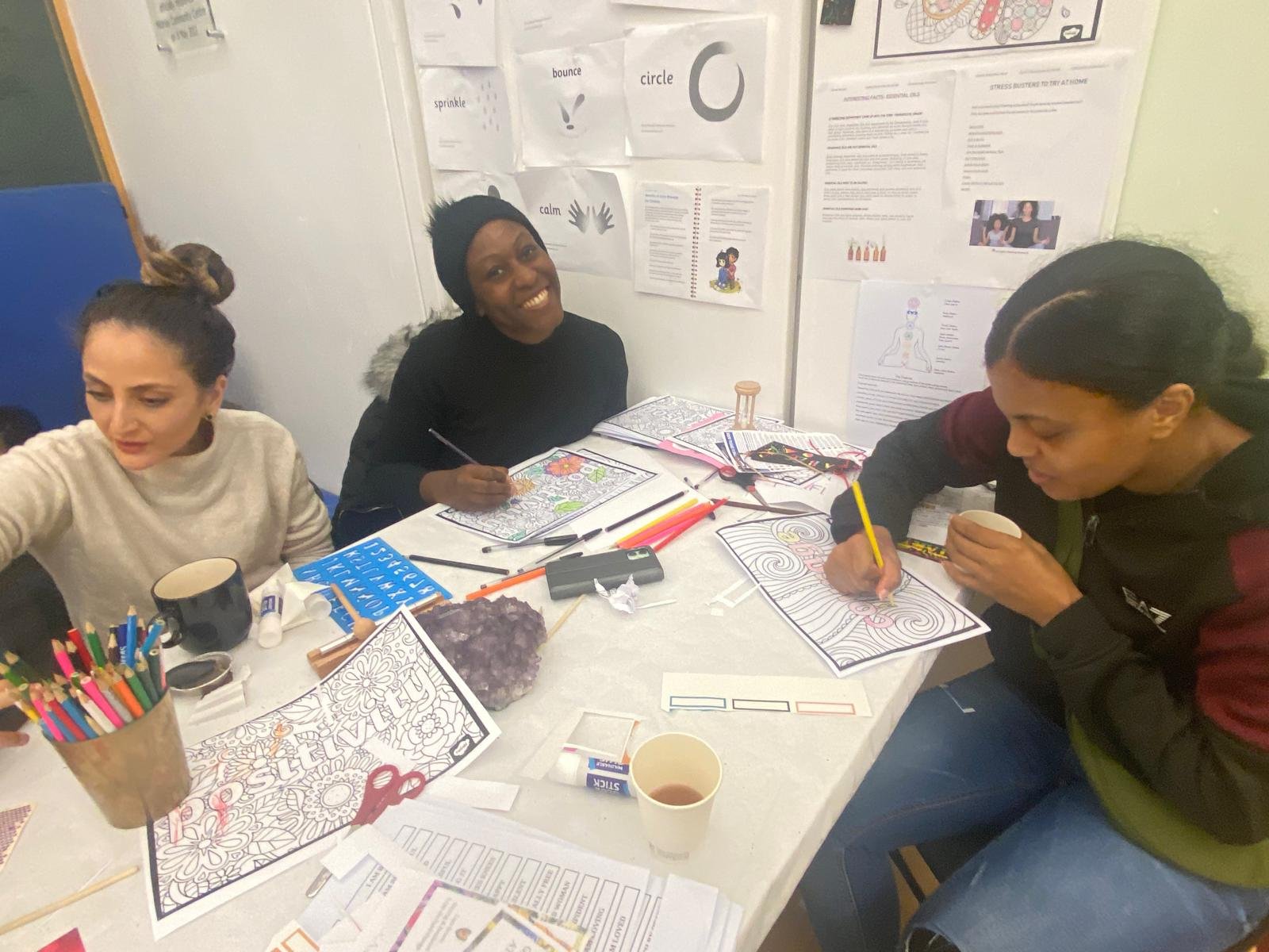 Participants taking part in a creative wellbeing workshop focused on relaxation and self-expression.