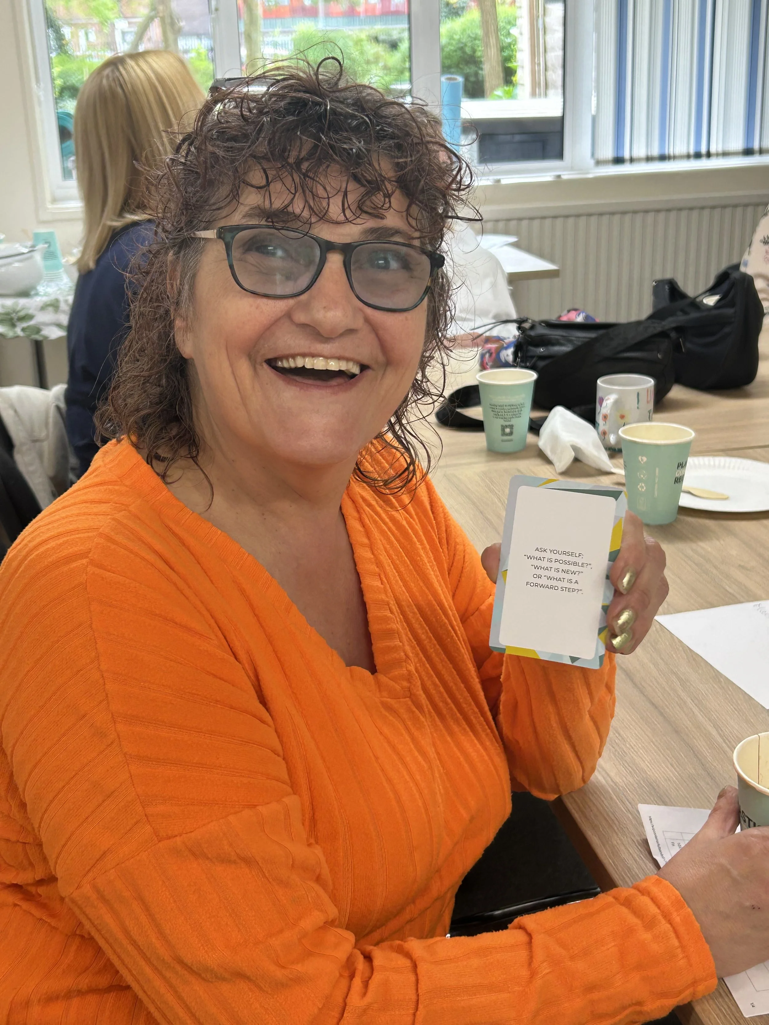 Participant taking part in a wellbeing workshop designed to encourage reflection, confidence and personal wellbeing.