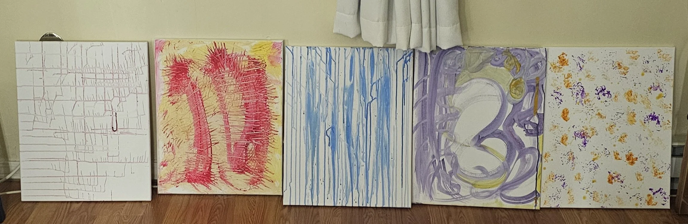Five abstract underpaintings by Vanessa Quiñones leaning side by side: letting go, anger, sadness, courage and celebration.