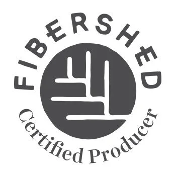 Fibre Shed Certified Producer logo featuring a clenched fist inside a circle with the text 'FIBER SHED' above and 'Certified Producer' below.