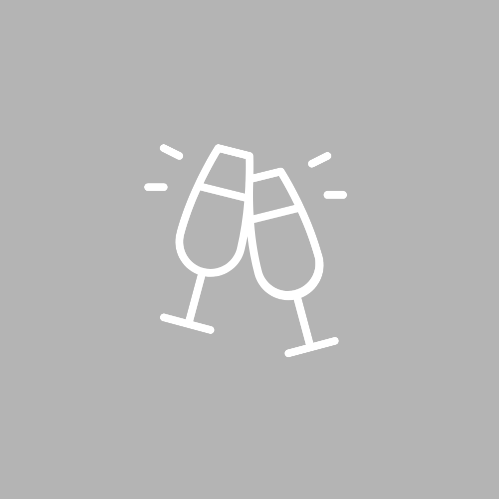 Two clinking champagne glasses celebrating.