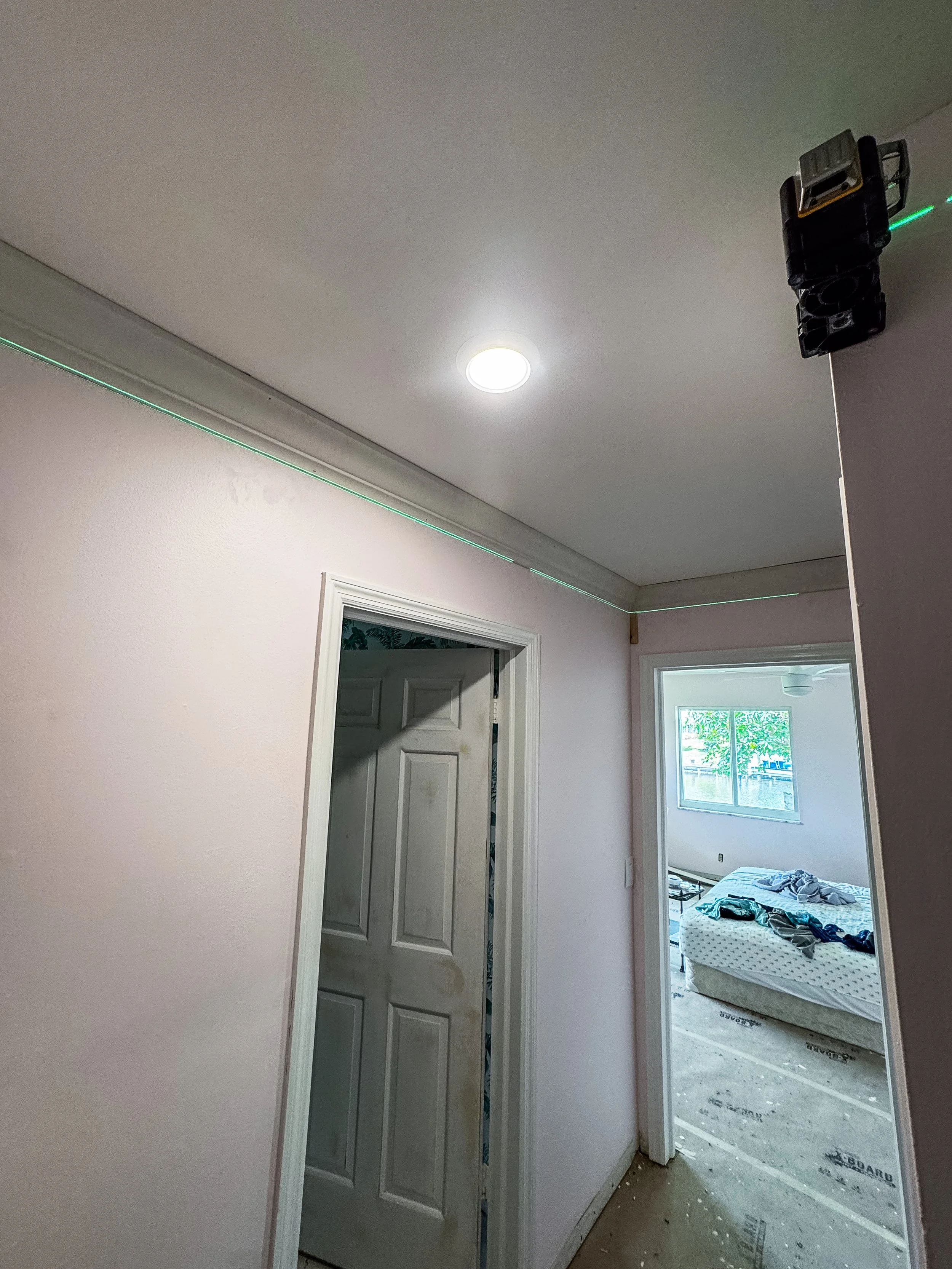 View of a room under renovation with unfinished flooring