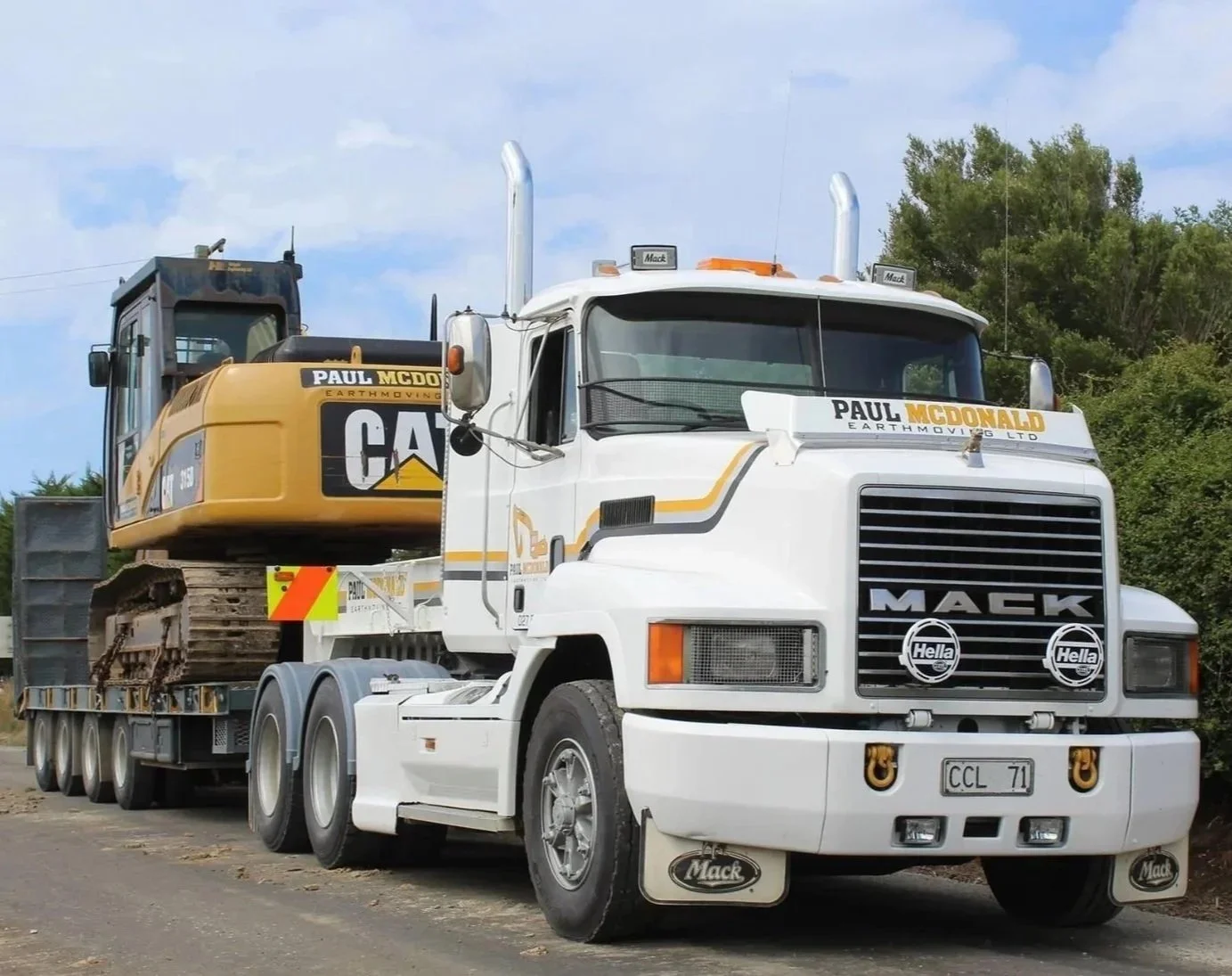 Paul McDonald Earthmoving truck carrying an excavator on a trailer, heading to a worksite in Otago.