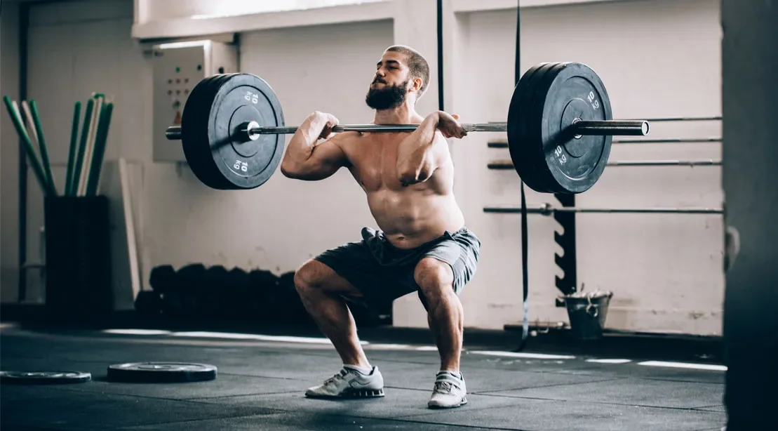 Barbell squat exercise in a gym