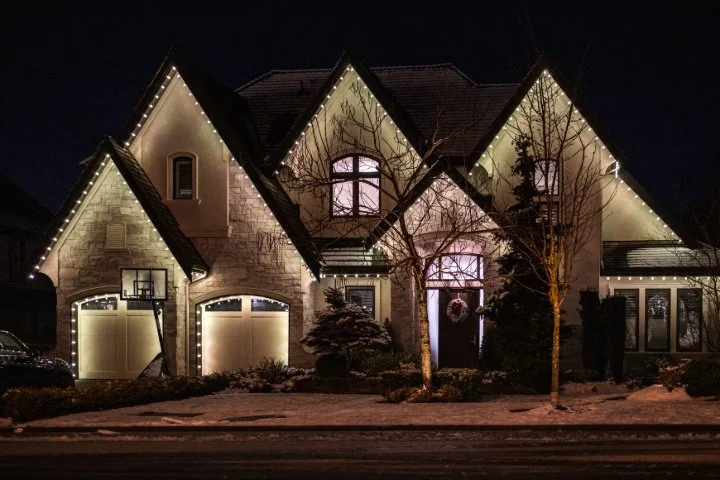 Warm white LED Christmas light installation on a two-story home in Boise