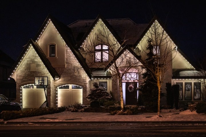 Warm white LED Christmas light installation on a two-story home in Boise