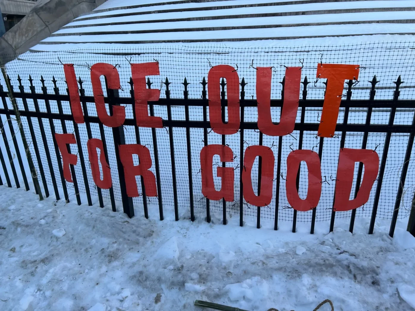 "ICE OUT FOR GOOD" in red lettering on the fence outside of the Upper Darby municipal building. photo credit: delco times