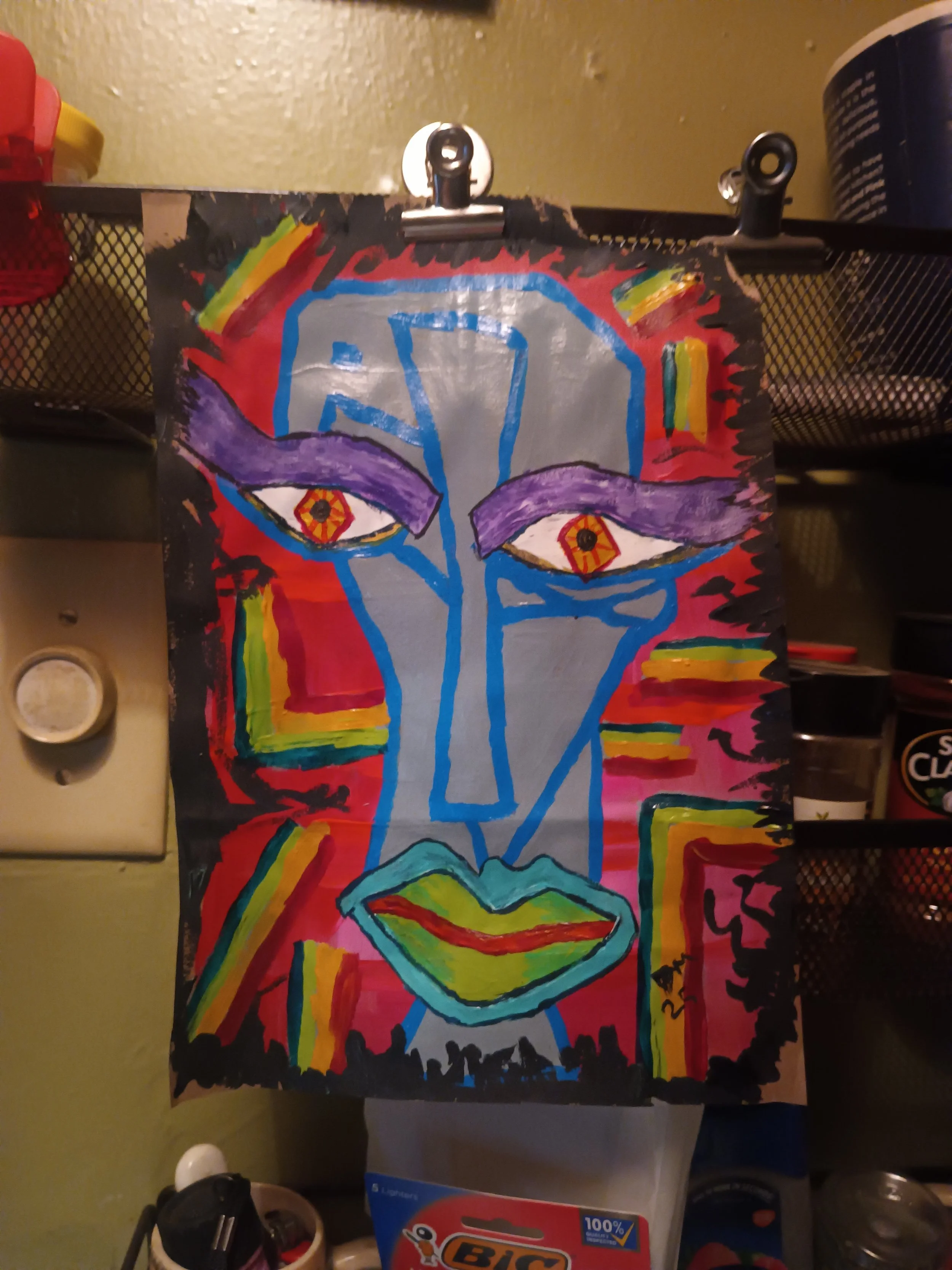 Colorful abstract painting of a face with purple eyebrows, yellow and red lips, and orange eyes with black pupils, on a dark background with rainbow accents.