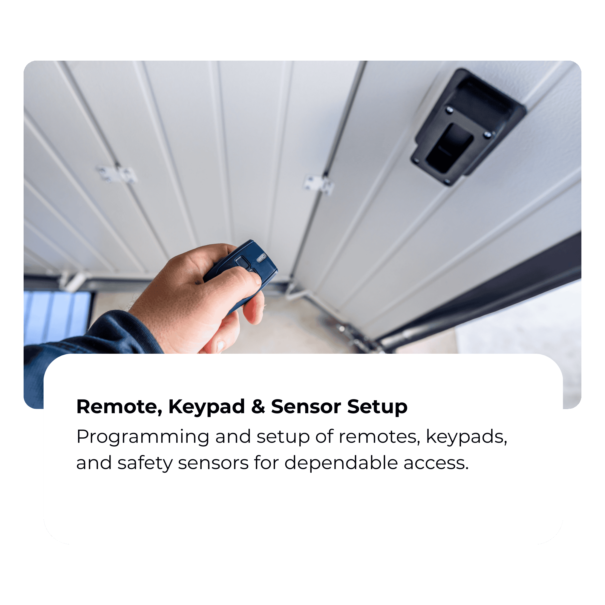 Person holding a remote control near a garage door sensor, with a nearby keypad on the wall, for programming and setup of remotes, keypads, and safety sensors.