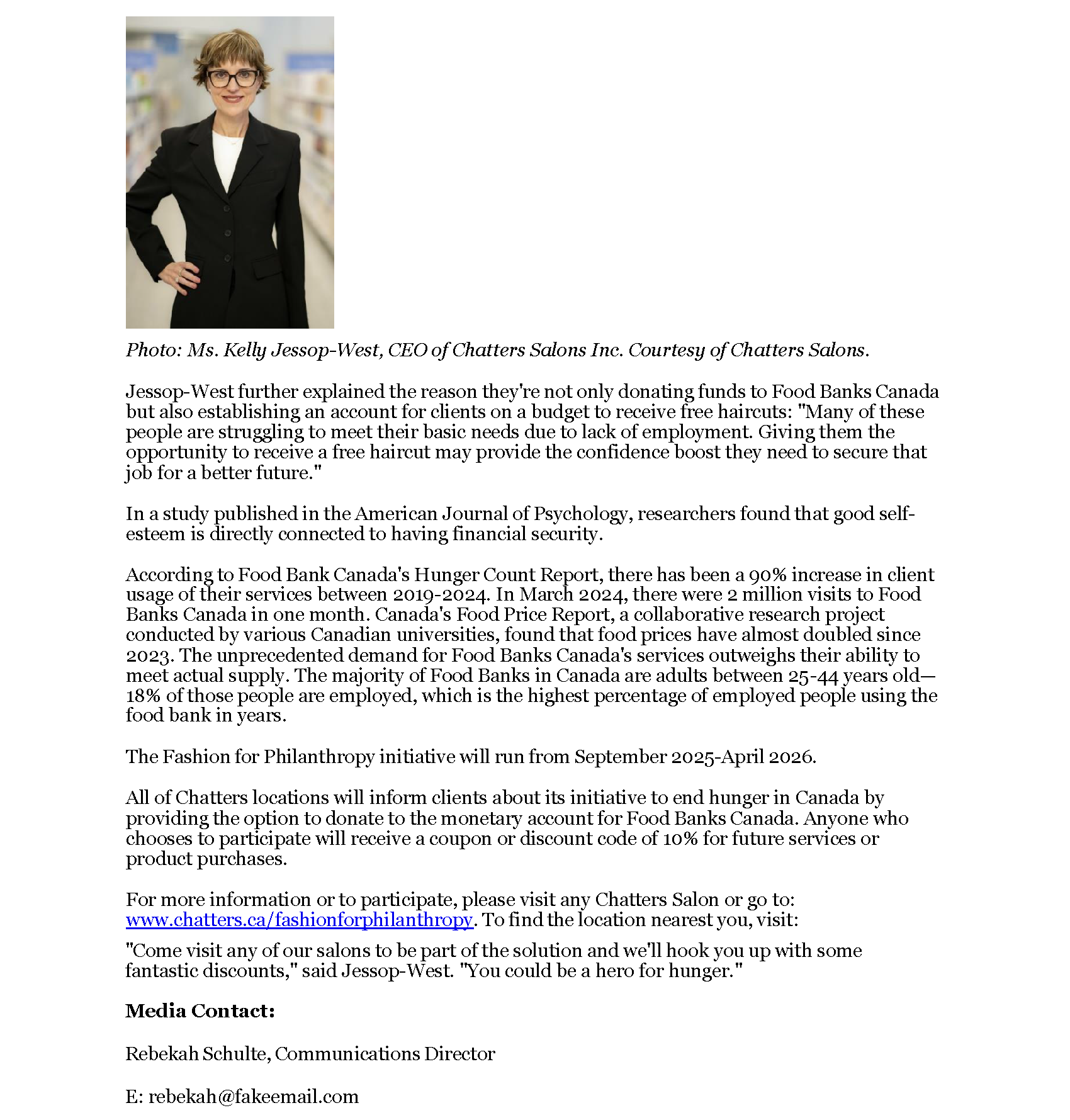 A woman with short light brown hair, wearing glasses, a black blazer, and a white top, standing in a retail store aisle.