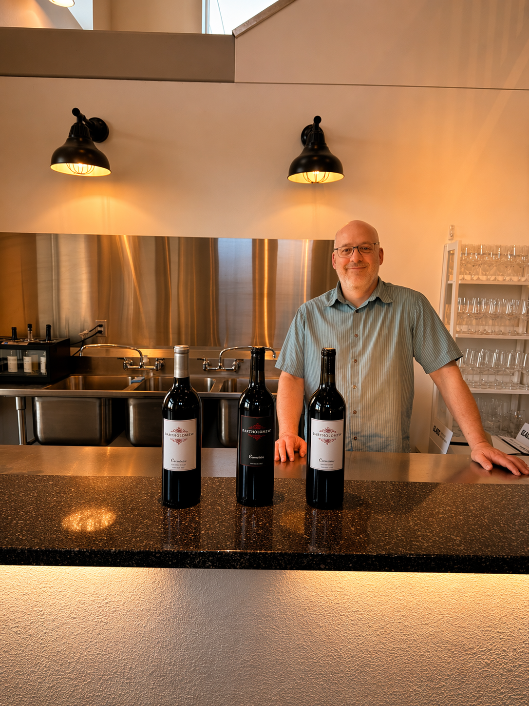 Winemaker Bart Fawbush standing behind the counter at Bartholomew Winery in Kennewick.