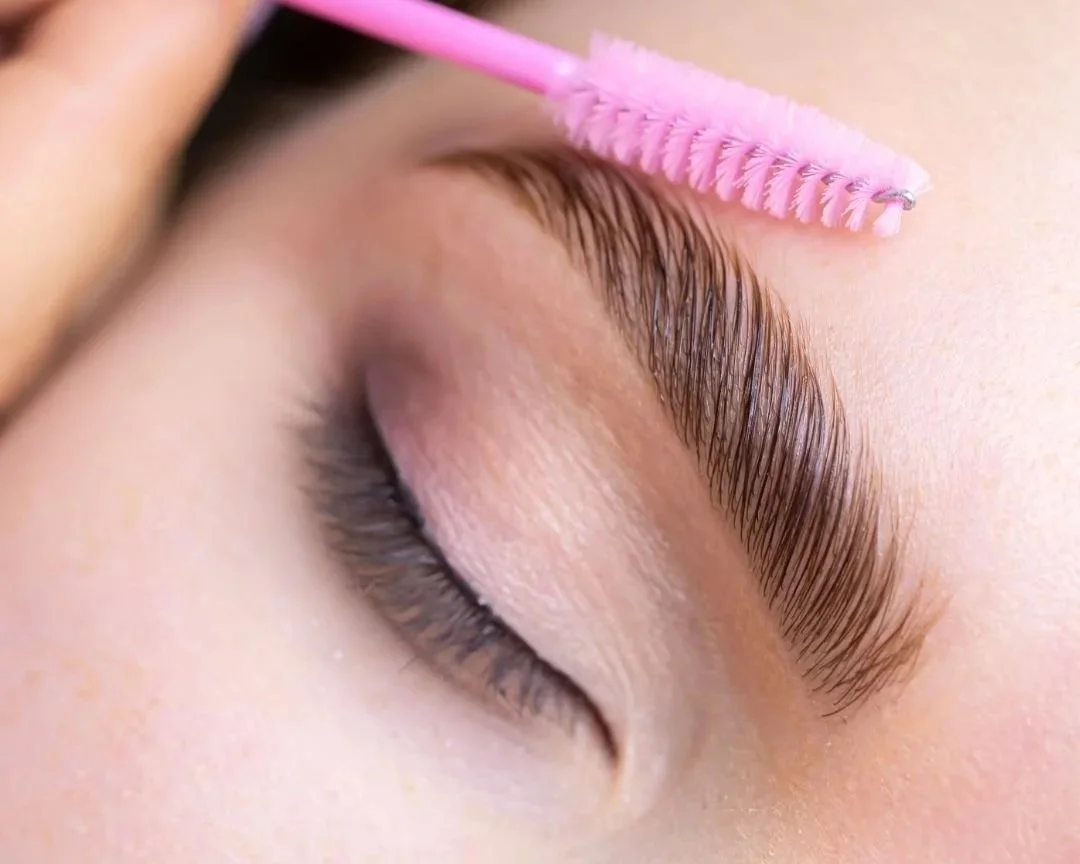 women brushing waxed brows