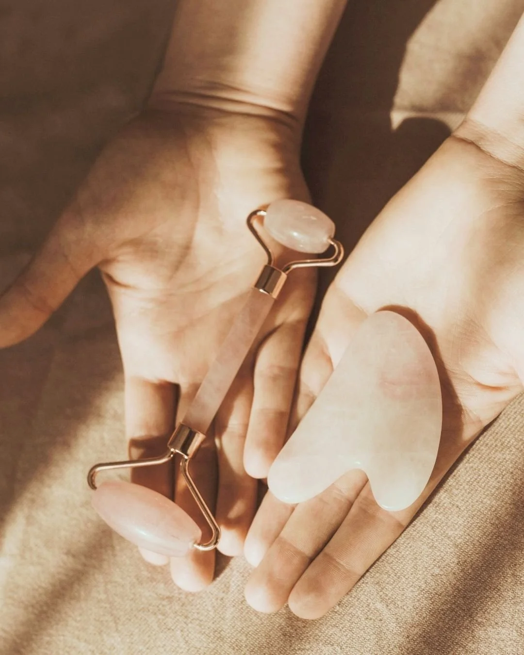 Hands holding gua sha tools