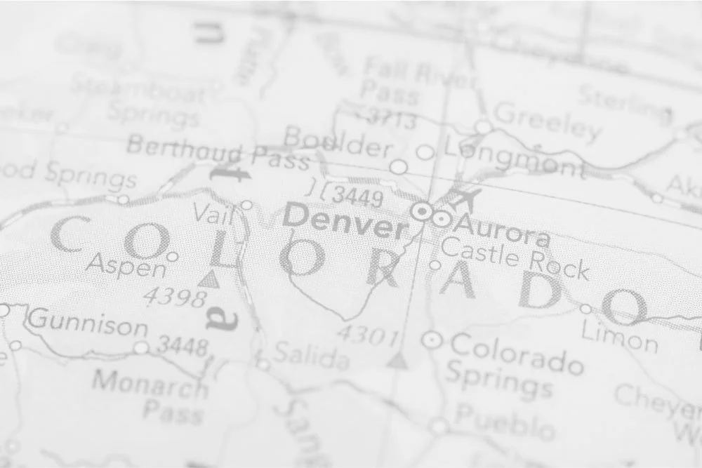 Close-up of a map showing Denver, Colorado, and surrounding areas, including mountain ranges and nearby towns.