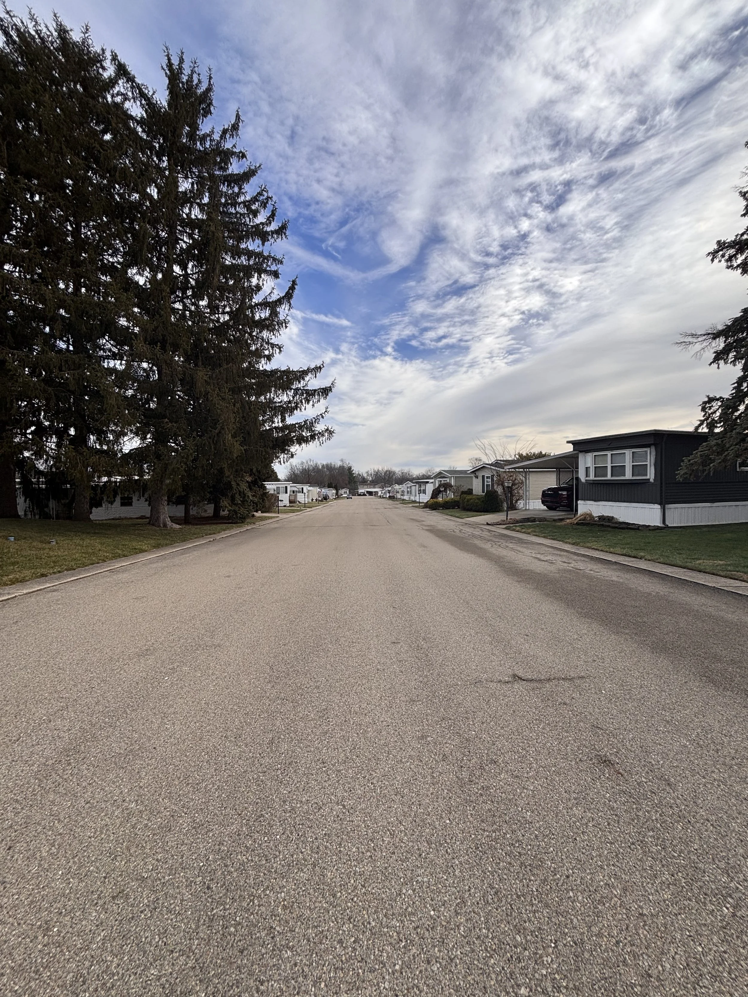 Street with manufactured homes at Red Oak Mobile Home Park a 55 and over community