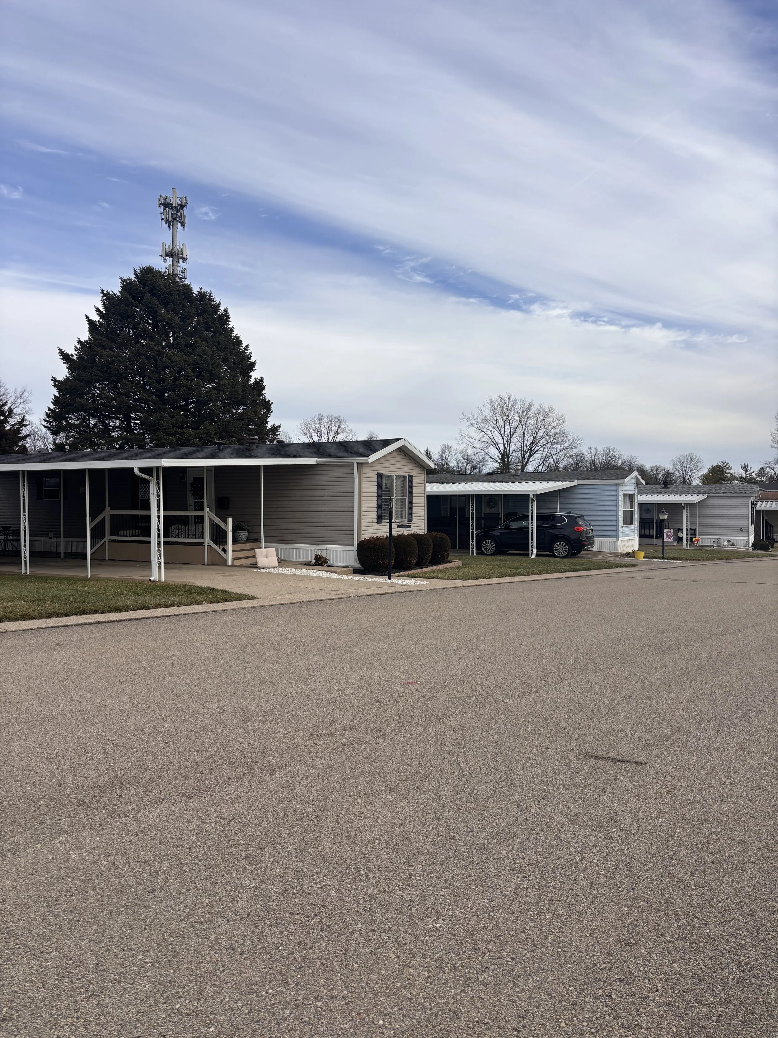 Street with manufactured homes at Red Oak Mobile Home Park a 55 and over community