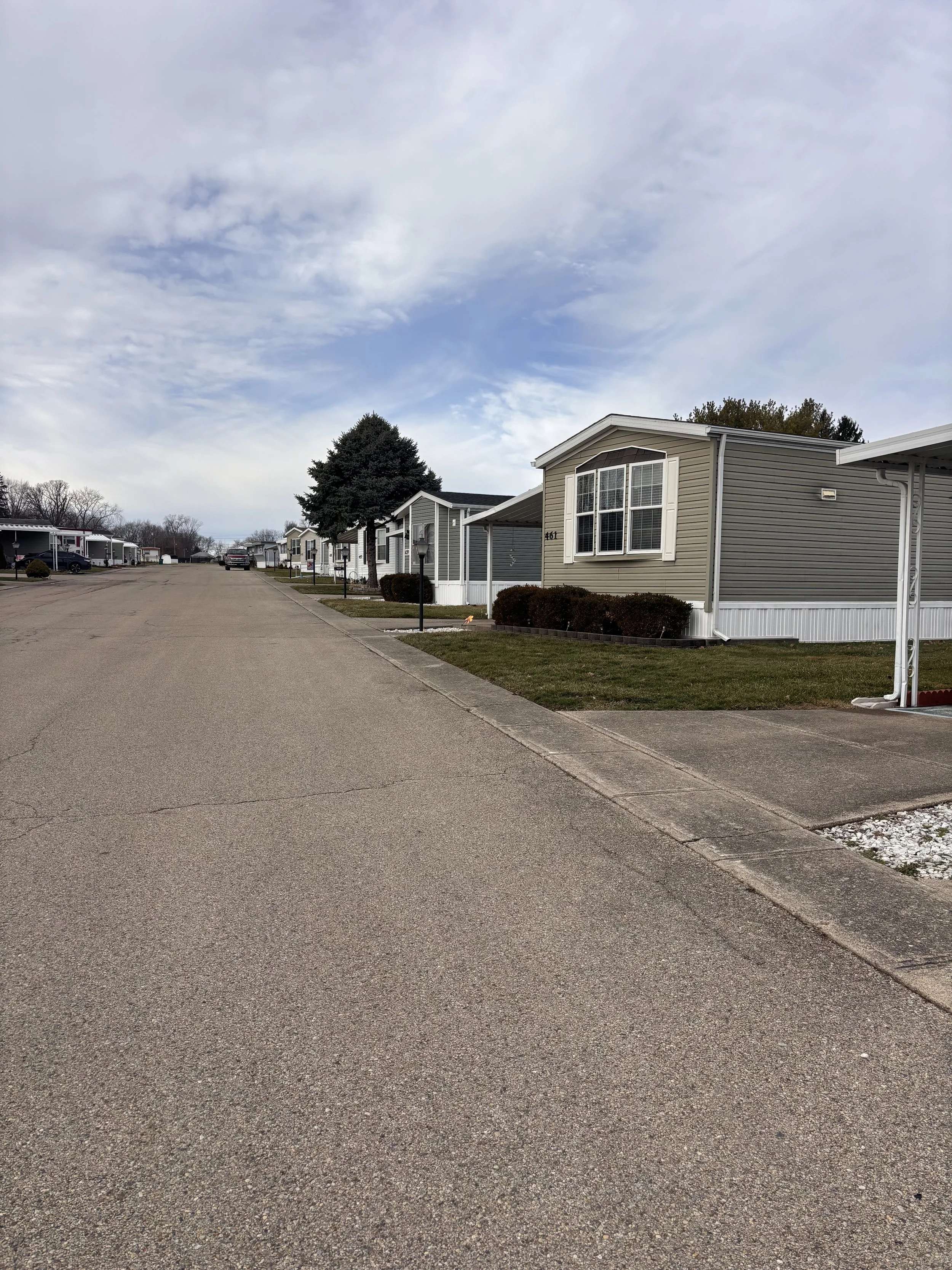 Street with manufactured homes at Red Oak Mobile Home Park a 55 and over community
