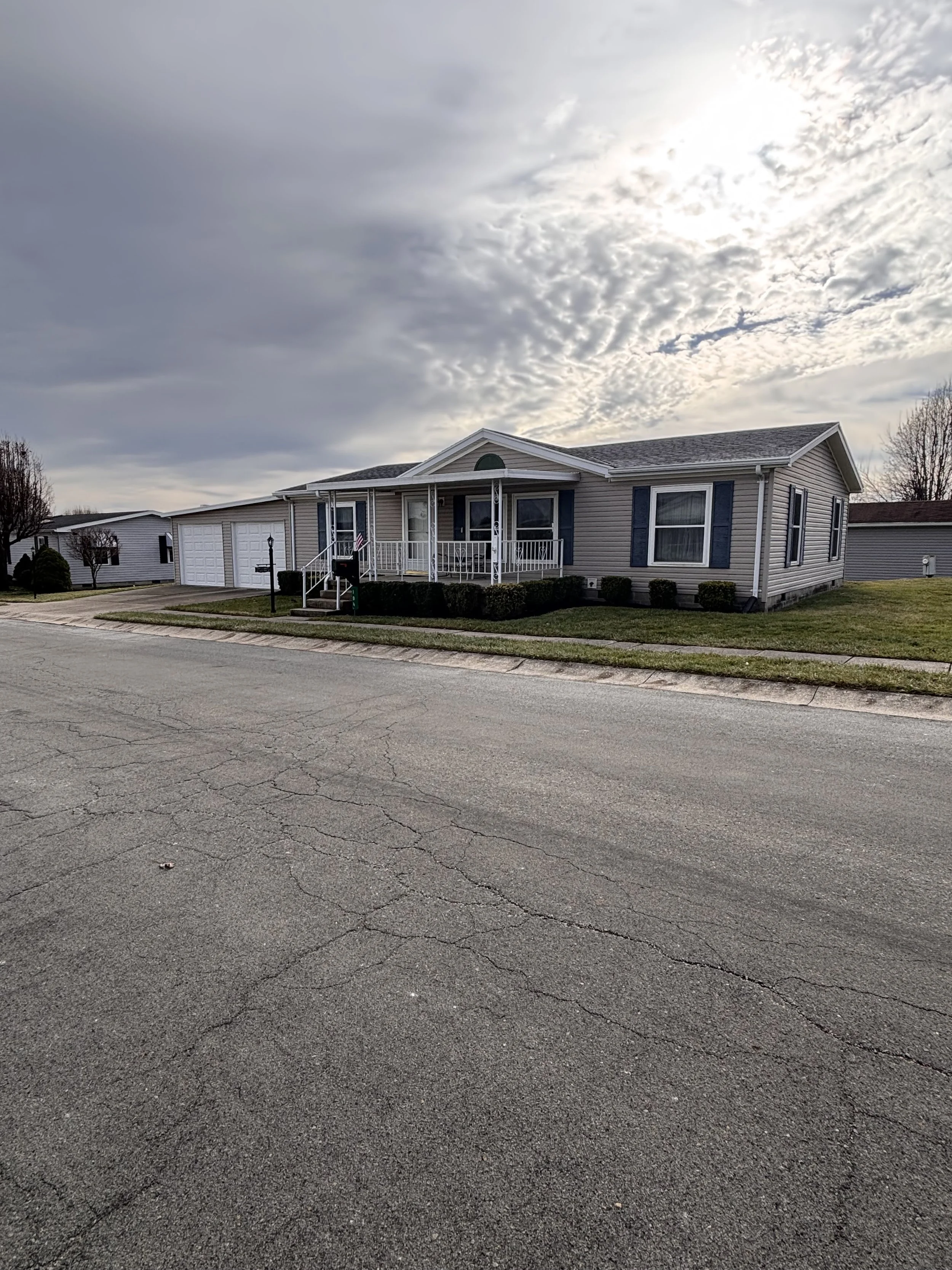 Manufactured home with garage and awning at South Point Village a 55 and over community
