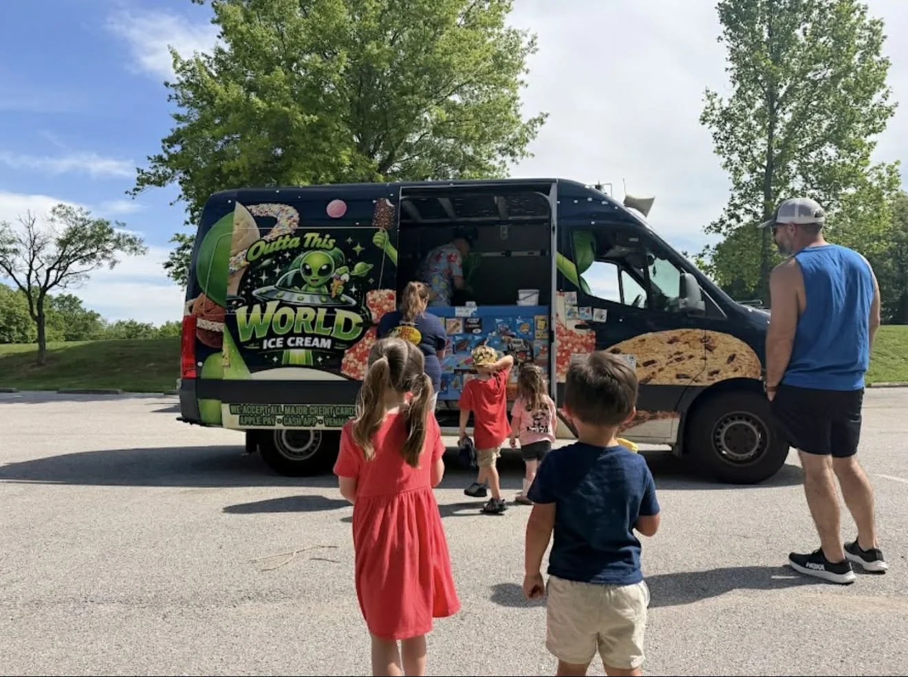 Outta This World ice cream truck serving customers at park event in St. Louis Missouri"