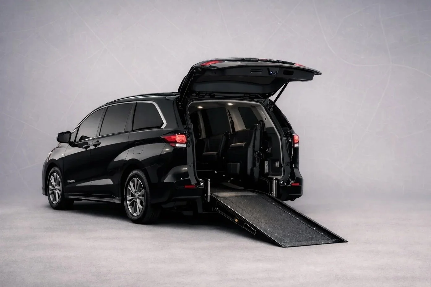 Med Black Transport vehicle equipped with rear-loading wheelchair access for safe, private, and dignified medical transportation