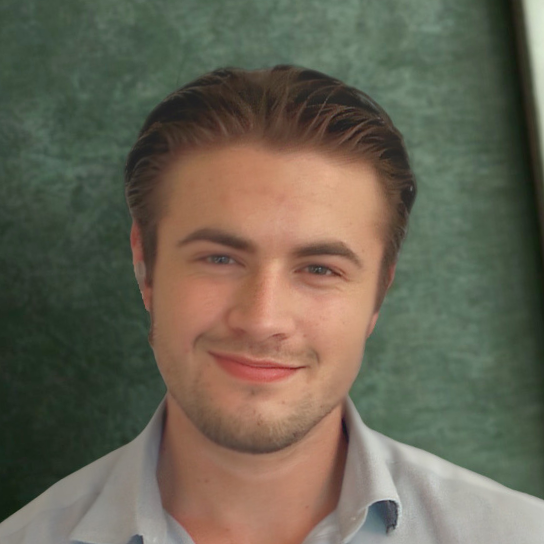 A young man with light brown hair, blue eyes, and a light complexion, smiling against a green background.