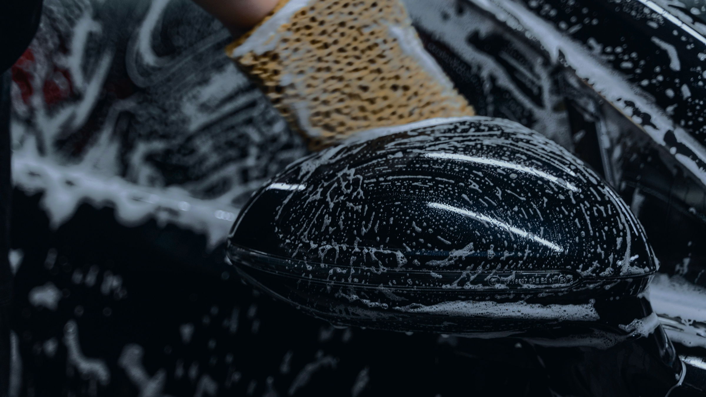 A black air fryer with soap suds inside.