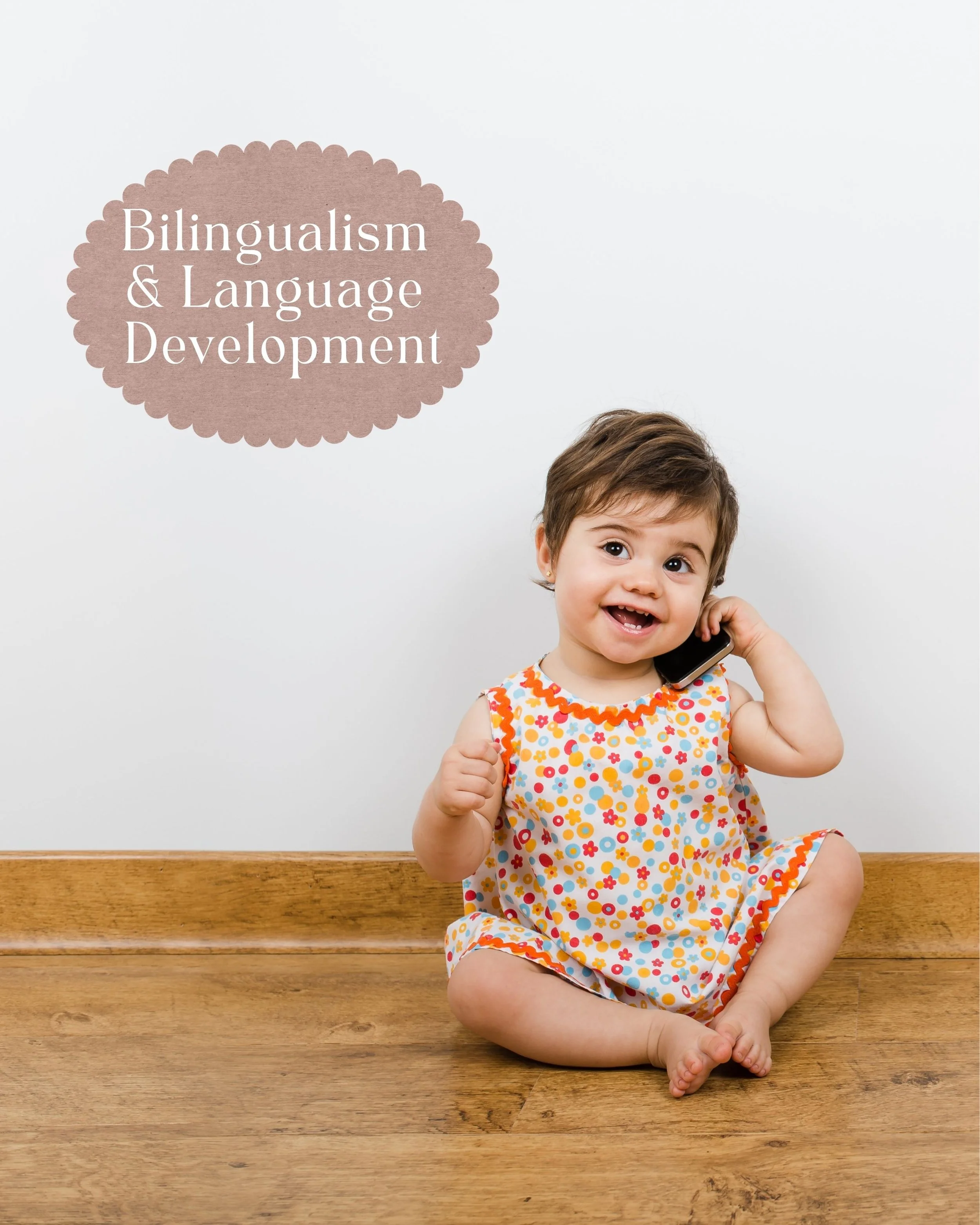A cute toddler is happy and smiling holding a cell phone, imitating talking on the phone.  The caption is "bilingualism & language development".