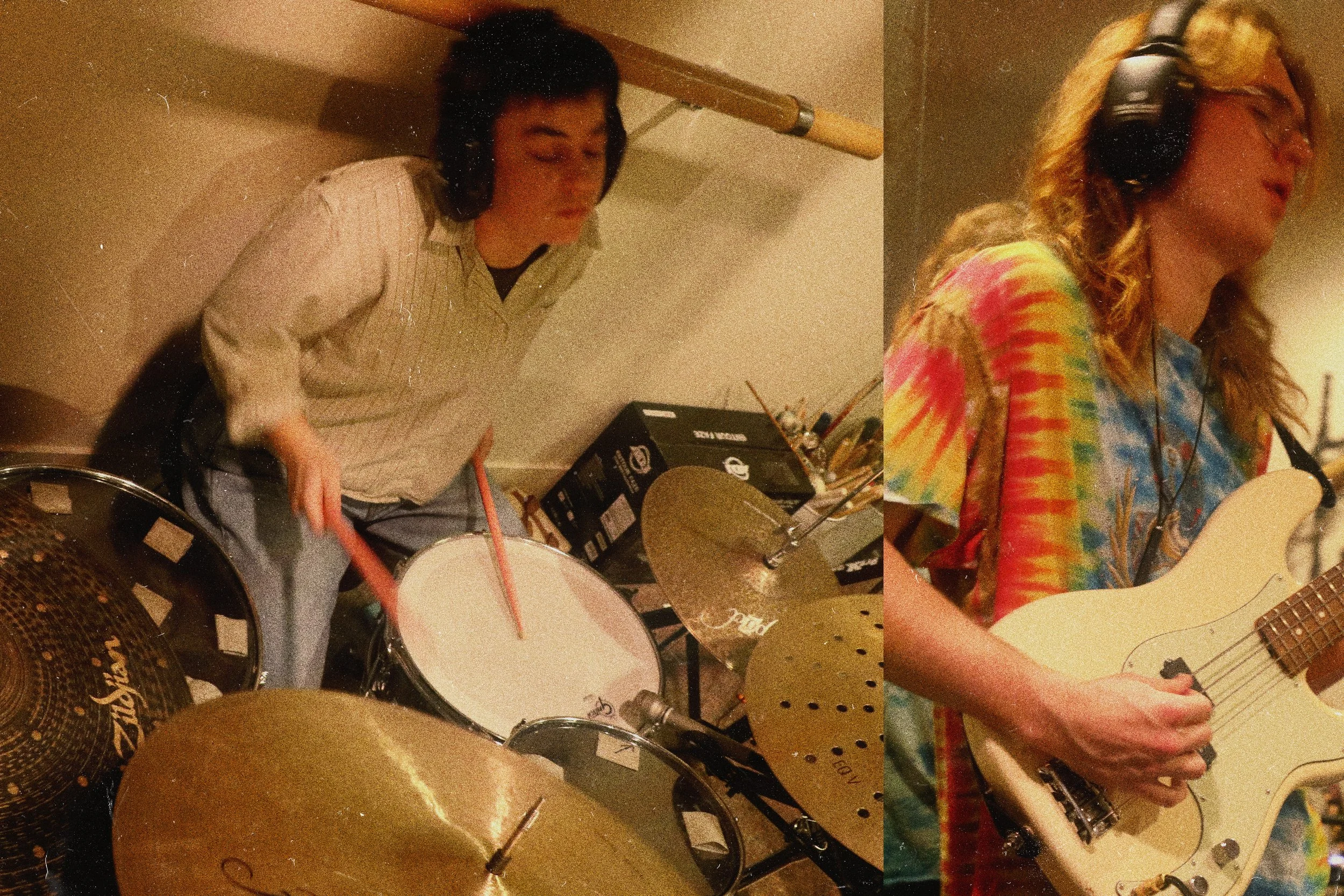 Two women recording music in a studio; one playing drums and the other playing electric guitar.