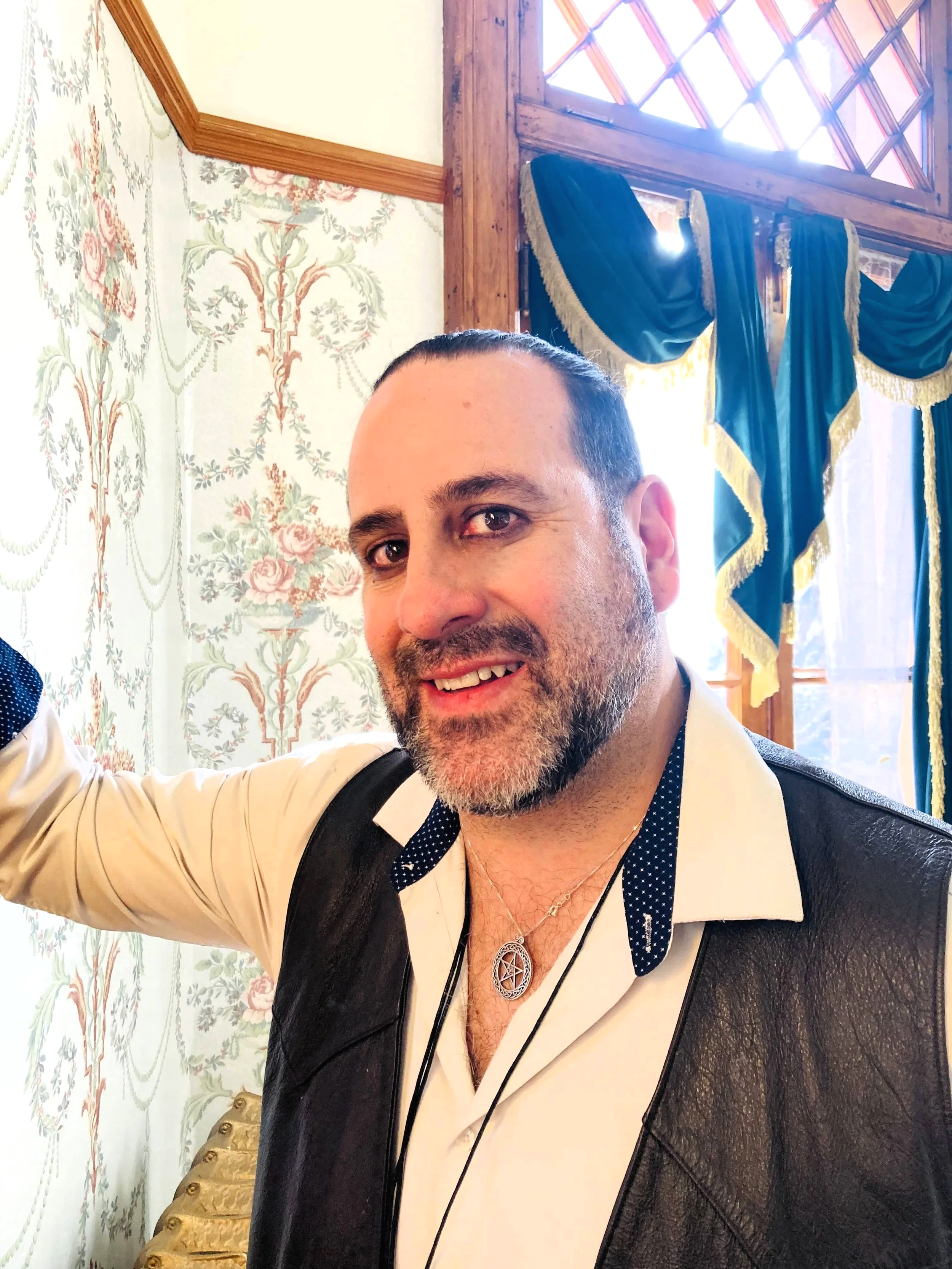 Paranormal investigator leaning on castle wall