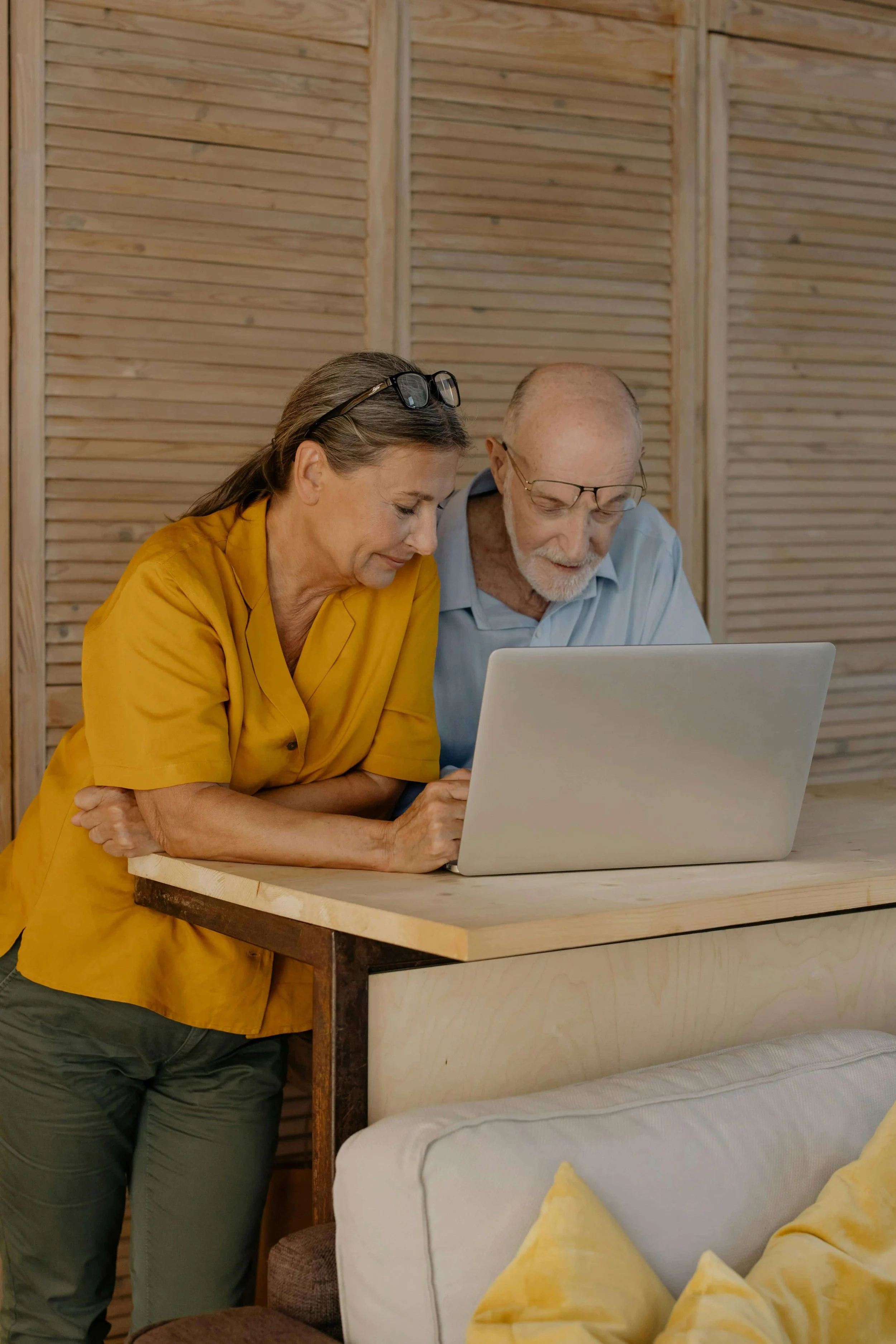 A man and woman looking at a laptop