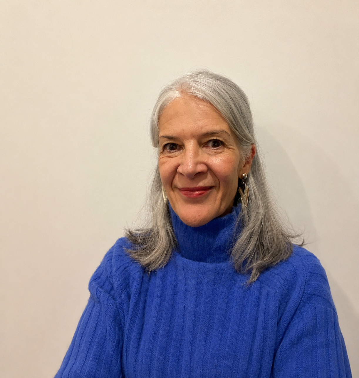 A woman in a blue jumper, smiling
