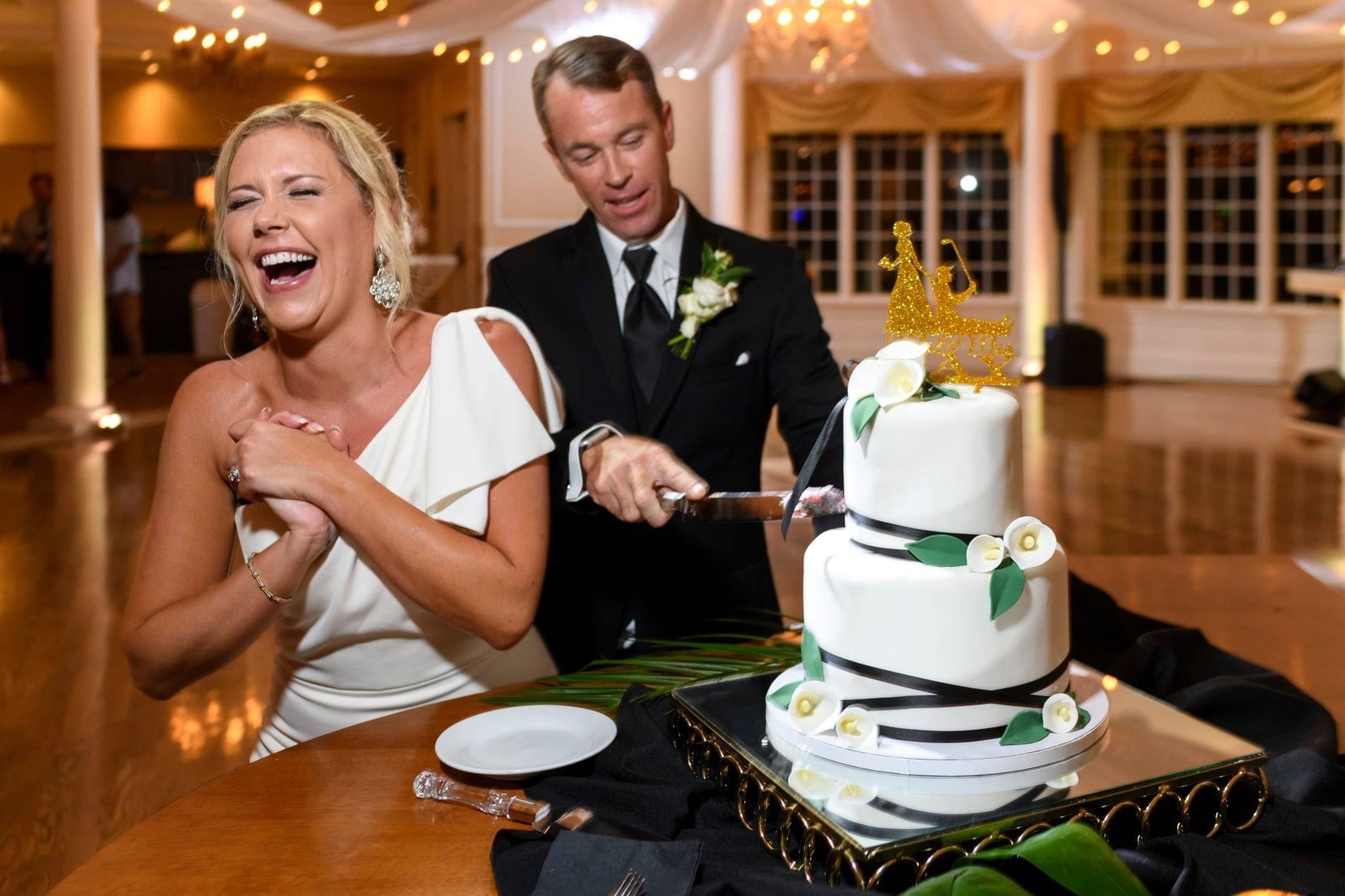 Contemporary white wedding cake at The River House ballroom with black and minimalist floral design by Sweet Weddings Cakes