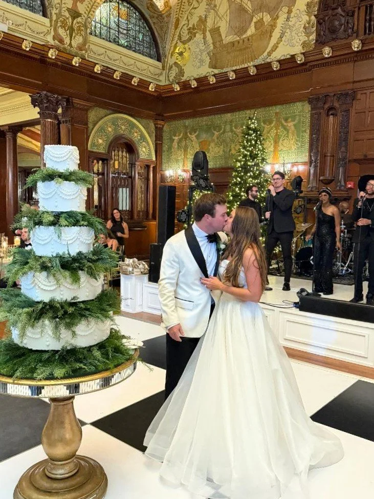 5-tier white wedding cake with greenery garlands at Flagler College Ponce de Leon Ballroom by Sweet Weddings Cakes