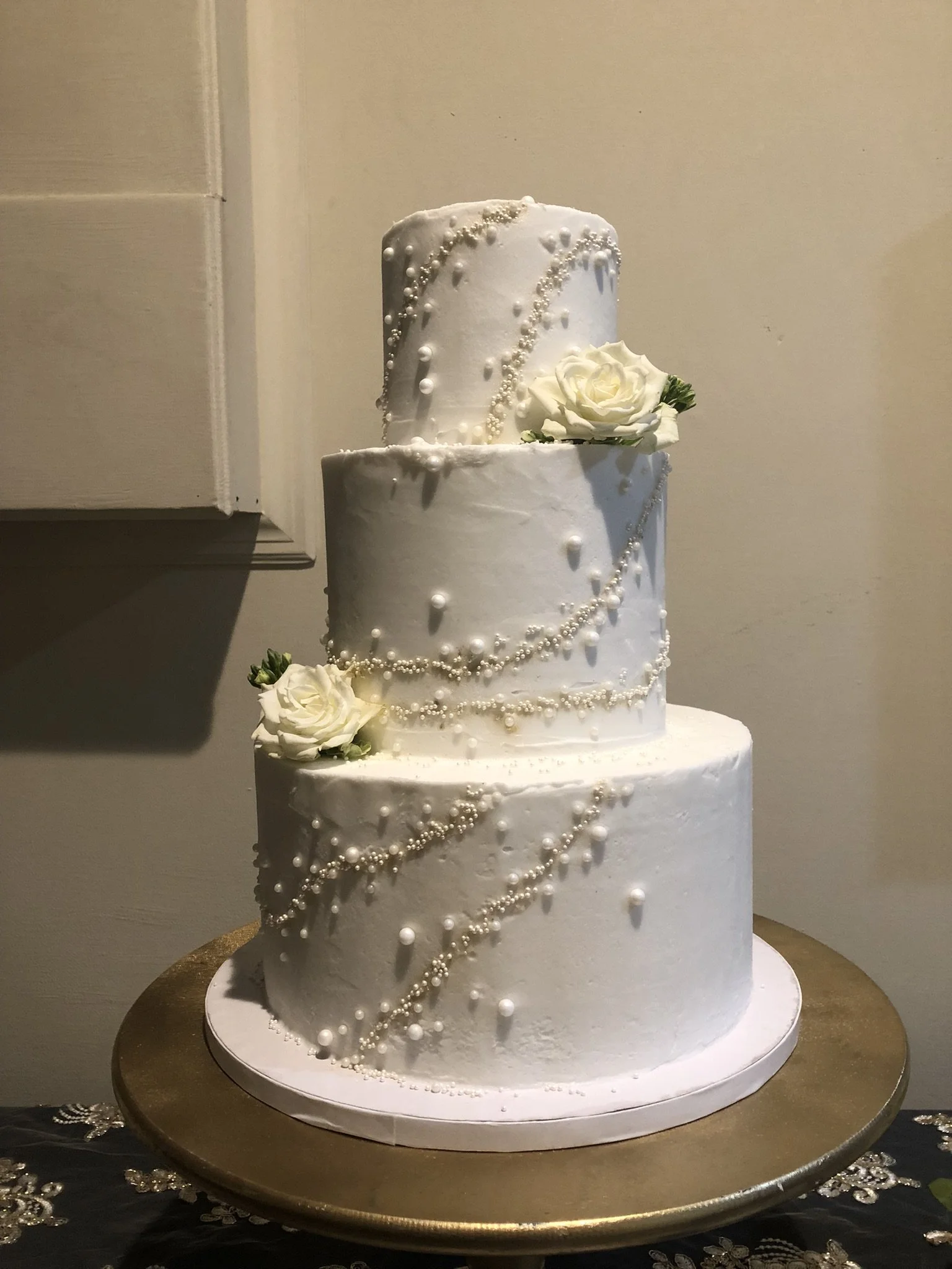 white cake with pearls and roses.JPEG