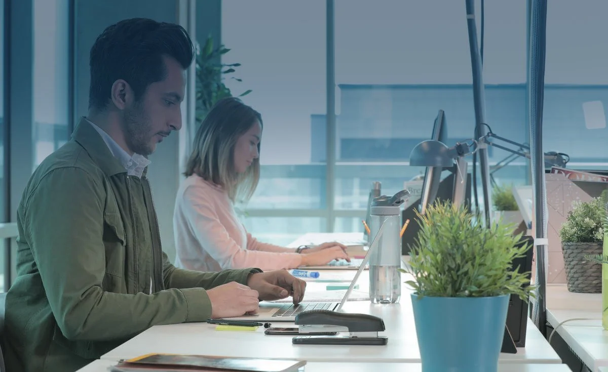 People working at desks in a modern office.