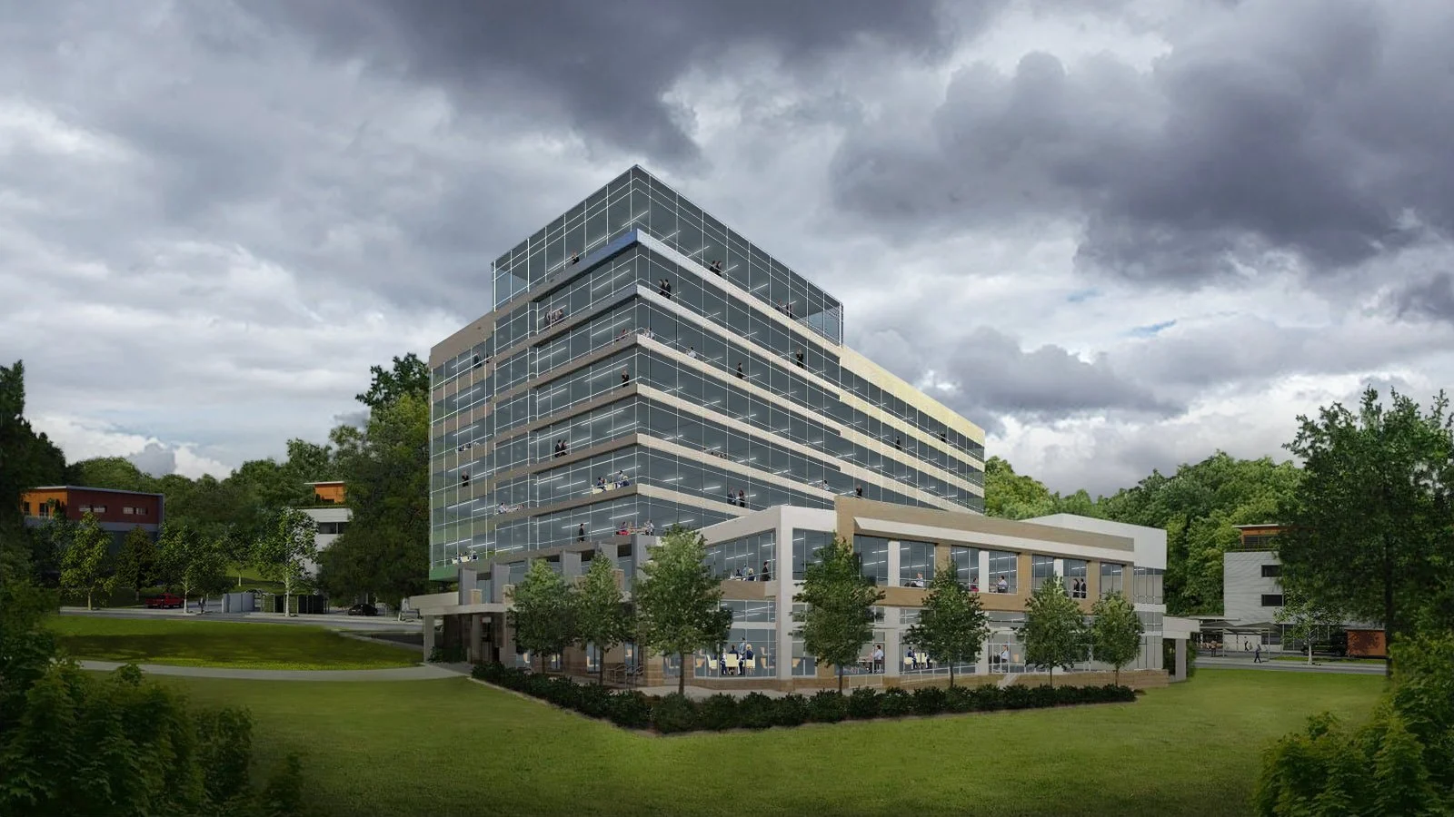 Modern multi-story office building with glass facade, surrounded by greenery and trees, under a cloudy sky.