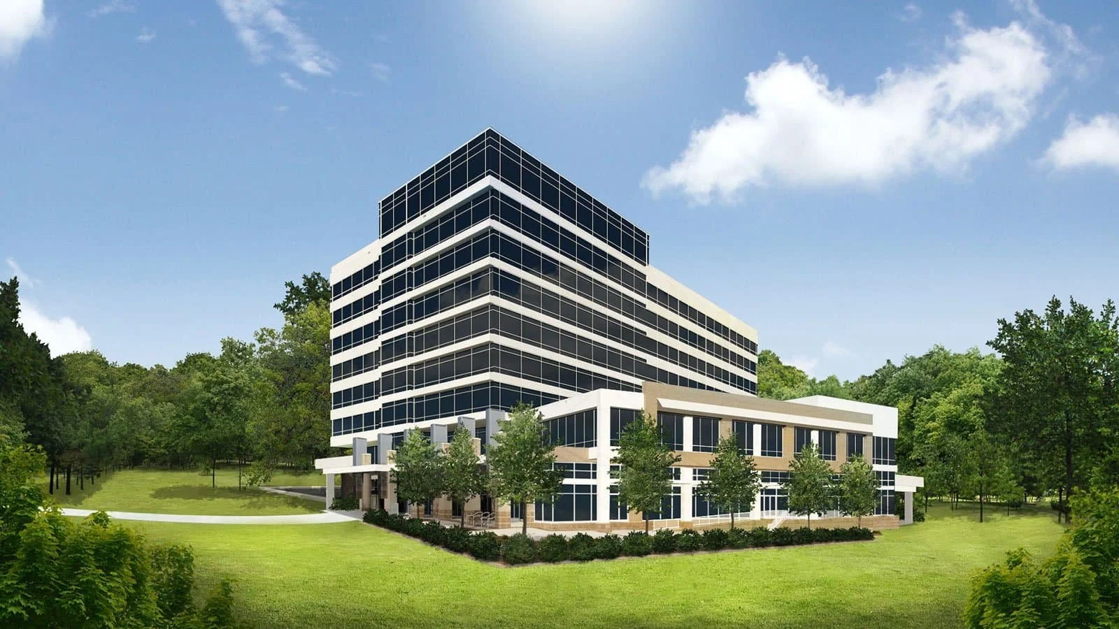 A modern multi-story office building with glass windows, surrounded by green trees and a well-maintained lawn, under a partly cloudy sky.