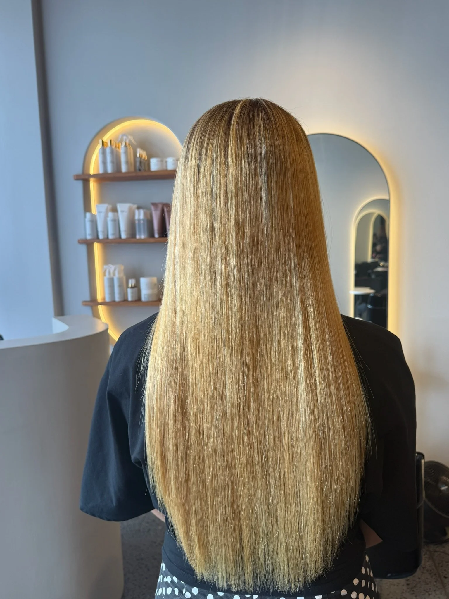 After Nanoplasty hair straightening showing long smooth sleek blonde hair result at Straight & Sleek salon.