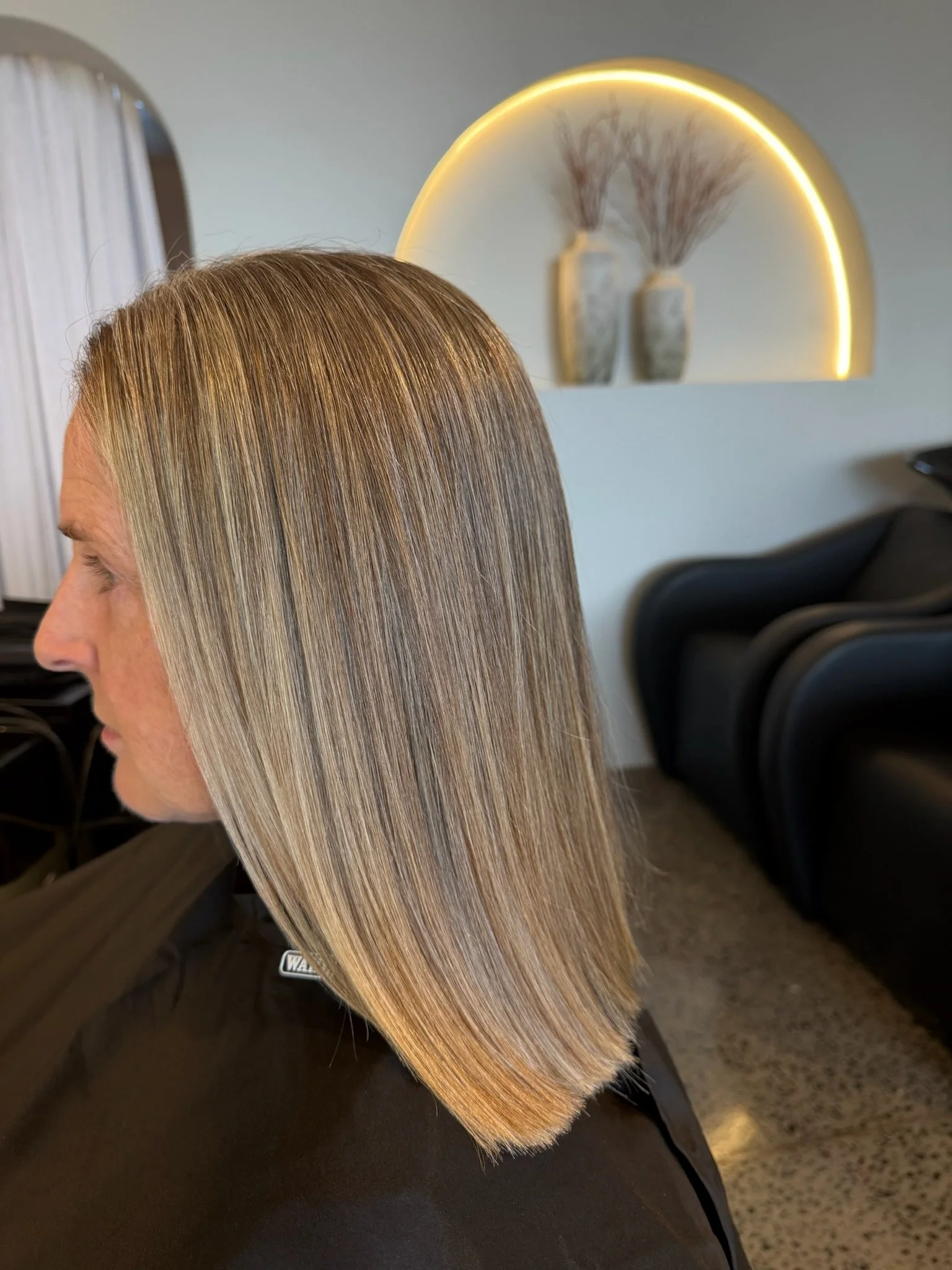 After Nanoplasty hair straightening showing smooth sleek blonde hair result at Straight & Sleek salon.