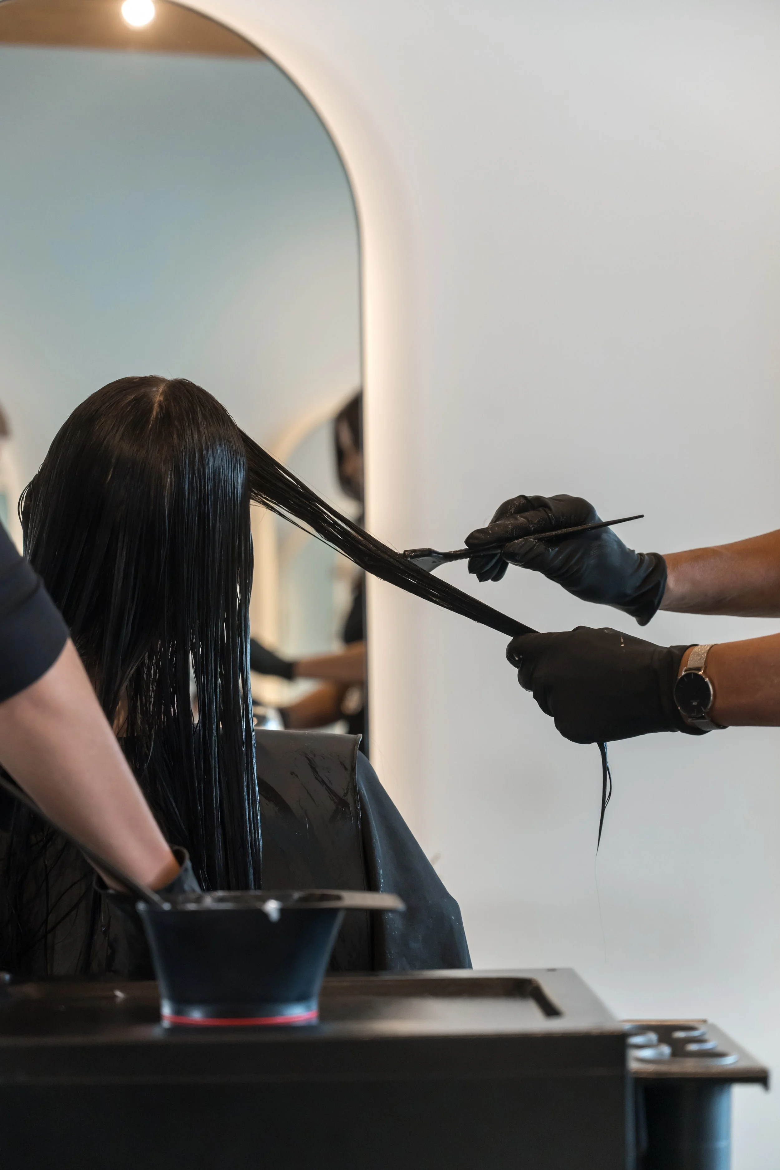 Nanoplasty hair straightening treatment being applied to clients at Straight & Sleek salon.