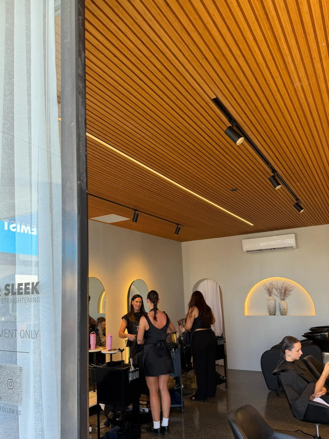 Nanoplasty hair straightening treatment being applied to clients at Straight & Sleek salon.