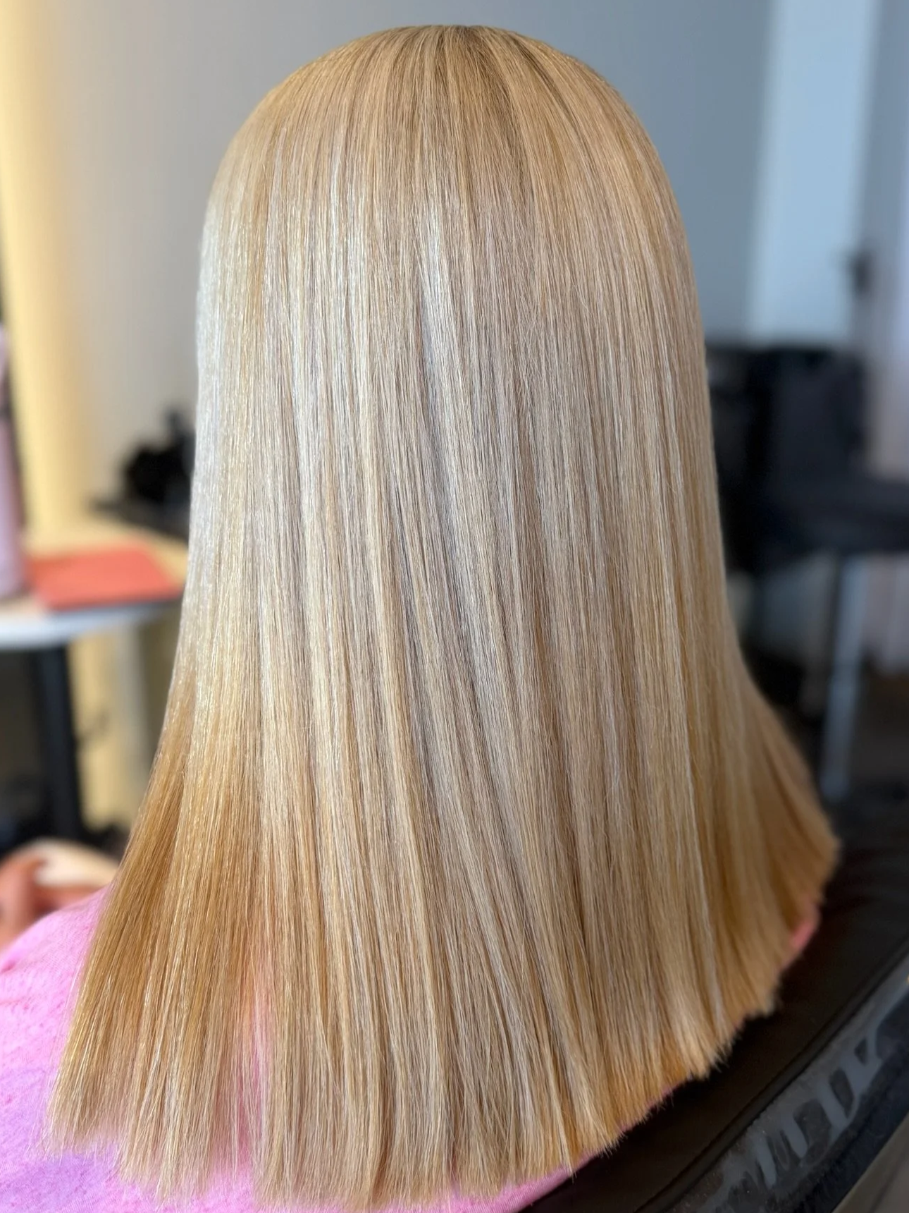 After Nanoplasty hair straightening showing smooth sleek blonde hair result at Straight & Sleek salon.