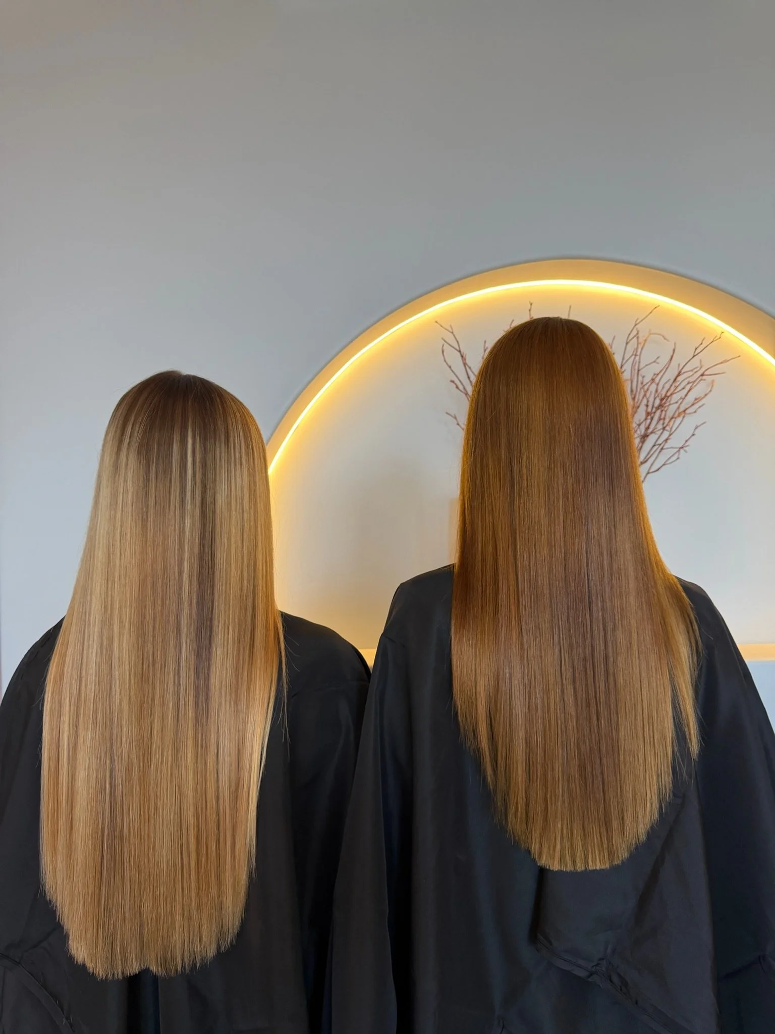 Two clients with long smooth sleek hair after Nanoplasty hair straightening treatment at Straight & Sleek salon