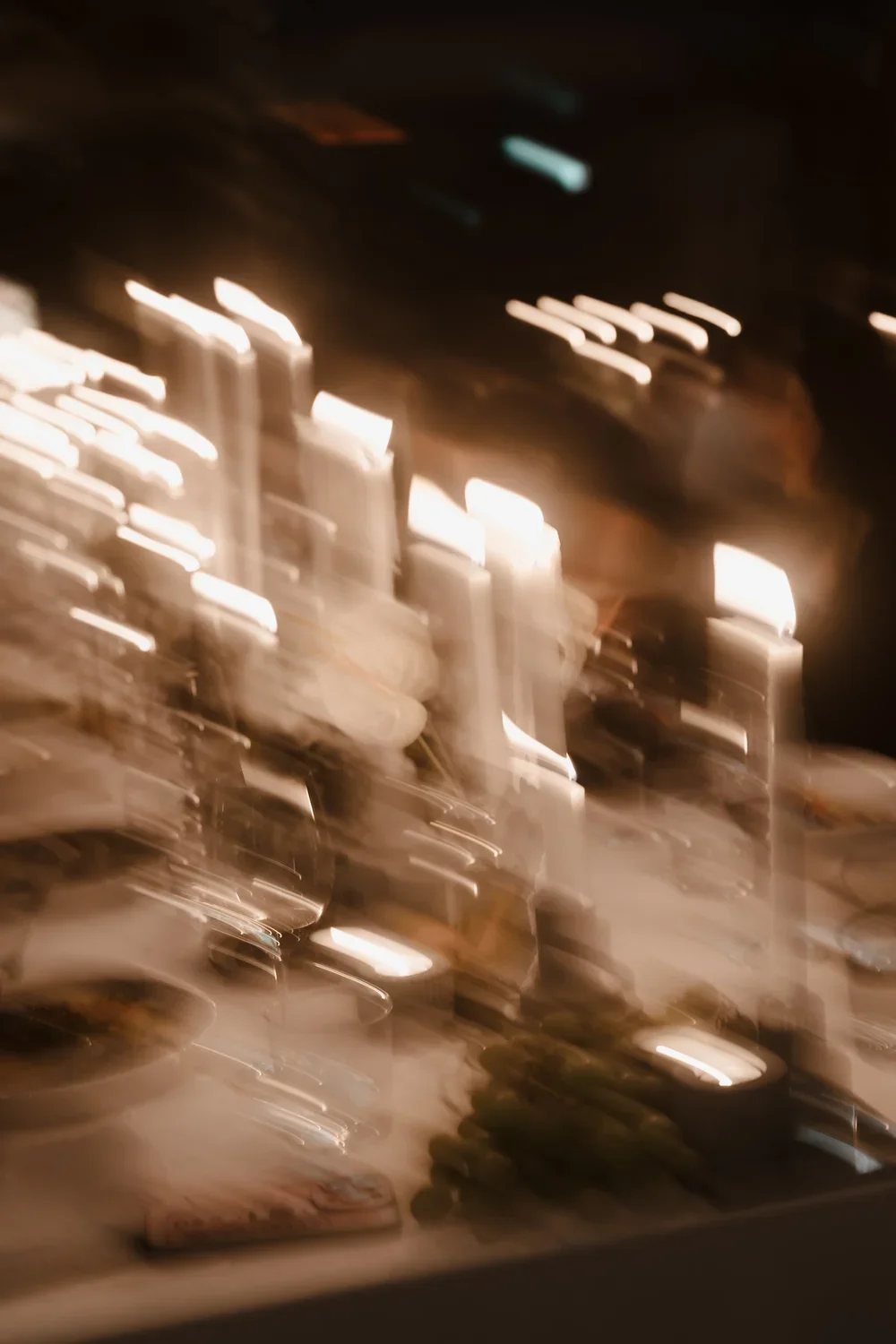 Blurred image of a romantic, candle lit tablescape for Ever After Effect.