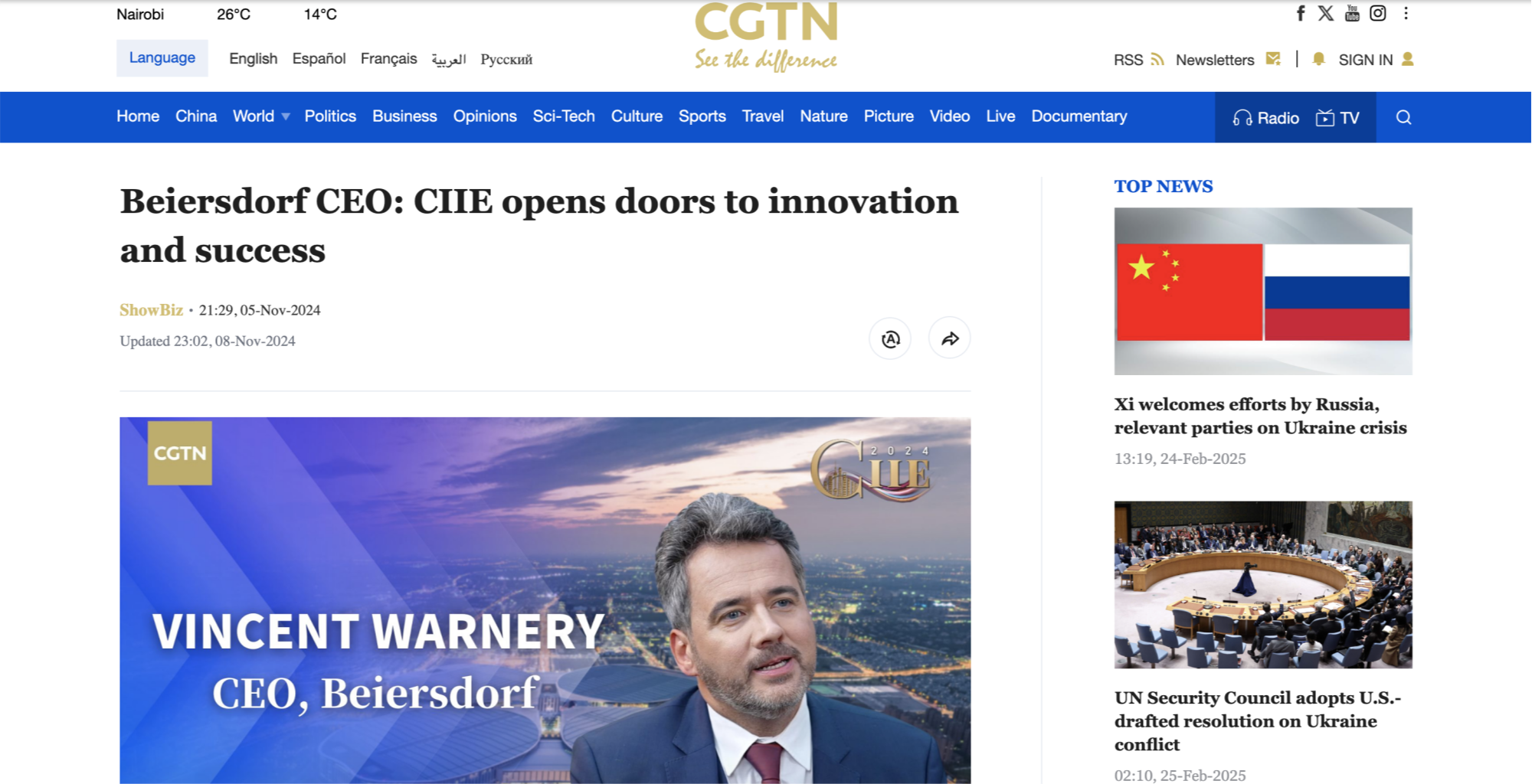 Screenshot of a news article on CGTN's website titled 'Beiersdorf CEO: CIIE opens doors to innovation and success.' The article features a photo of Vincent Warnery, CEO of Beiersdorf, with a cityscape and a sunset in the background.