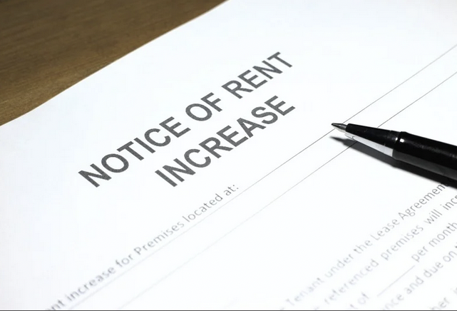 Notice of rent increase letter with a black pen placed on top.