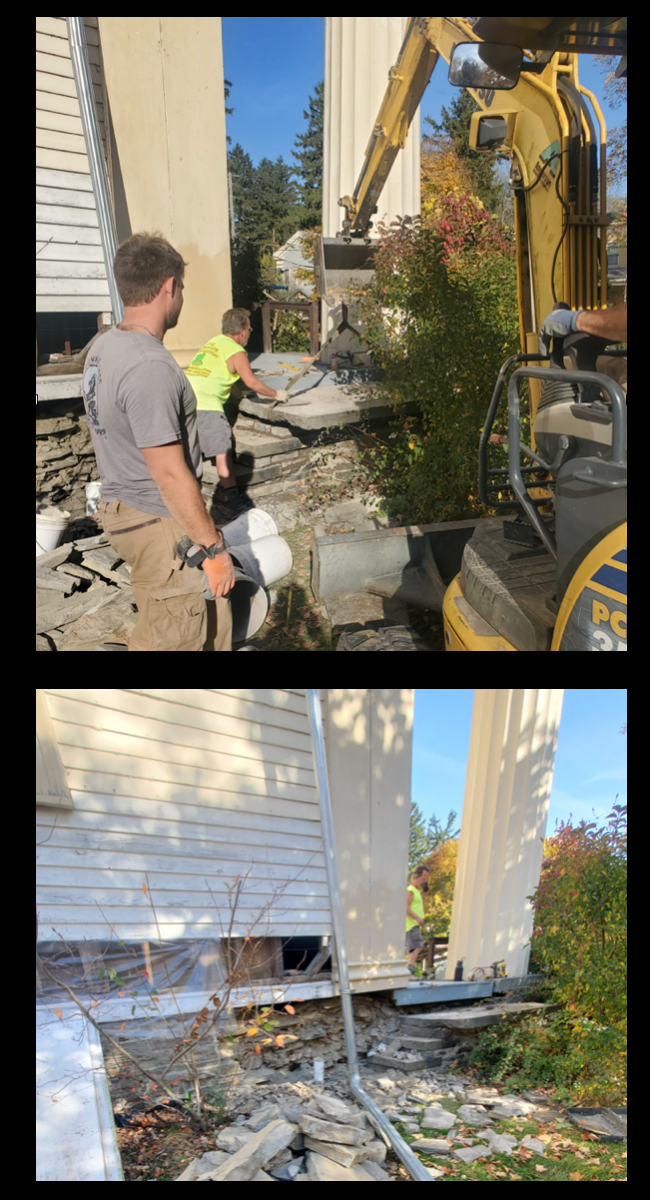 Construction site at TCFA where workers are repairing and rebuilding a damaged house, using an excavator to remove debris and replace the foundation; one person supervises, while another operates the equipment.