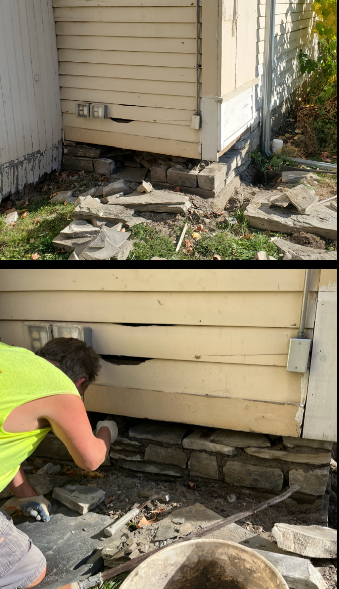 A person repairing the foundation at TCFA with stone bricks.